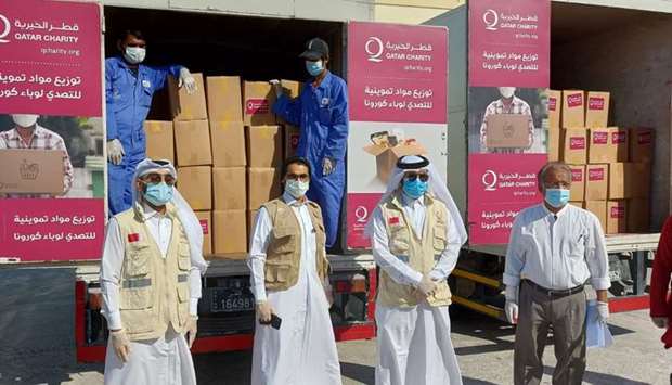 FOOD KITS: Qatar Charity handing over food kits to BCQ through MoI and MADLSA at a school premise.