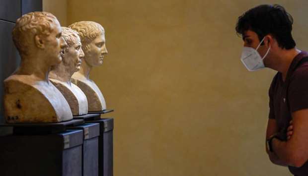 A visitor wearing a face mask views marble busts of the permanent collection at the Capitoline Museum (Musei Capitolini) in Rome after it reopened as Italy eased the lockdown imposed to curb the spread of the Covid-19 infection.