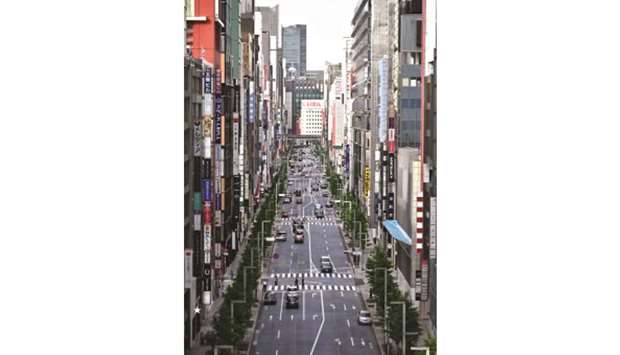 Motorists make their way through Ginza avenue in Tokyo yesterday. Japanu2019s PM lifted the state of emergency in the Tokyo region, after last week lifting it for the region around Osaka and Kyoto.