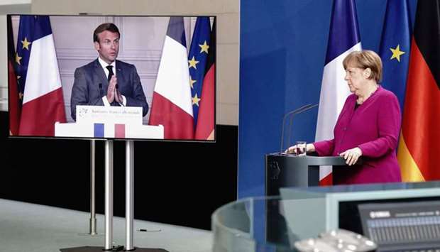 This photo taken on May 18 shows German Chancellor Merkel listening during a joint press conference with French President Emmanuel Macron, who attends via video link, at the Chancellery in Berlin, on the effects of the coronavirus pandemic. Merkel has been widely praised for keeping the coronavirus death rate in particular far lower than in many countries worldwide.