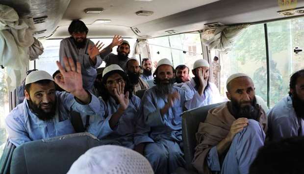 Afghanistan's (NCS) National Security Council, Taliban prisoners wave inside a vehicle during his release from the Bagram prison, next to the US military base in Bagram, some 50 kms north of Kabul yesterday. AFP/Afghanistan's (NCS) National Security Council.