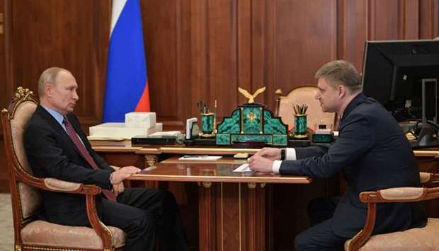 Russian President Vladimir Putin (L) speaks with with Russian Railways CEO Oleg Belozyorov during their meeting at the Kremlin in Moscow yesterday, as the country starts to ease lockdown measures taken to curb the spread of the Covid-19 pandemic, caused by the novel coronavirus.