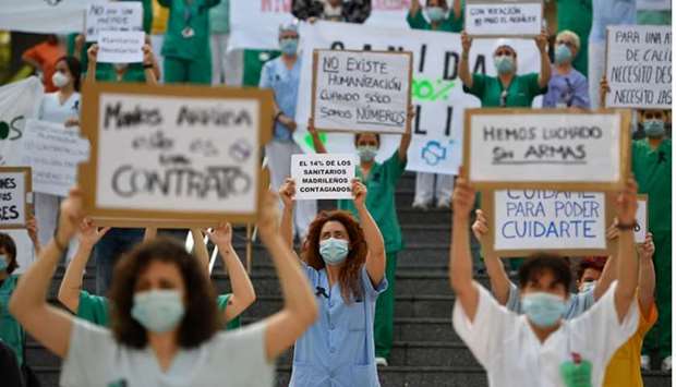 Healthcare workers protest, calling for a reinforced healthcare system, outside the Gregorio Maranon hospital in Madrid.