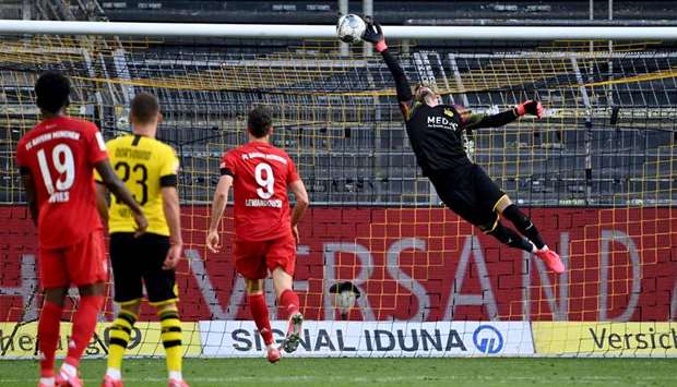 Dortmundu2019s goalkeeper Roman Buerki fails to keep out the goal scored by Bayern Munichu2019s midfielder Joshua Kimmich (not in picture) during their Bundesliga match in Dortmund yesterday. (AFP)