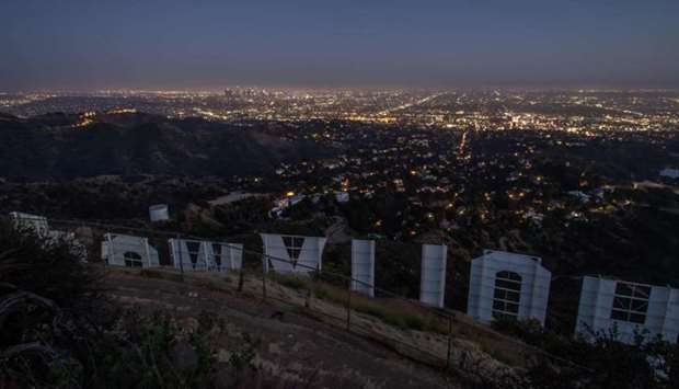 The Hollywood sign is pictured from the back at dusk during the second day of the Memorial Day holiday weekend, during the novel Coronavirus pandemic in Los Angeles, California on May 24
