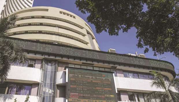 An electronic ticker board indicates stock prices at the Bombay Stock Exchange building in Mumbai. Supported by positive global cues, the Sensex soared 995 points to 31,605 while the Nifty settled 3% higher at 9,314 points yesterday.