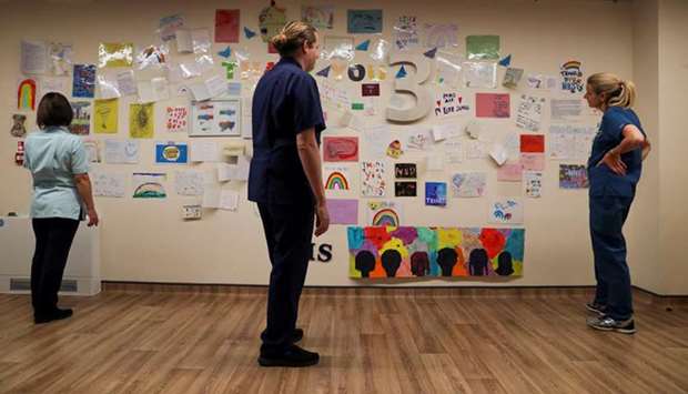A woman reads u2018Thank youu2019 messages stuck on a wall in the Emergency Assessment Centre at Wexham Park Hospital near Slough, Britain.