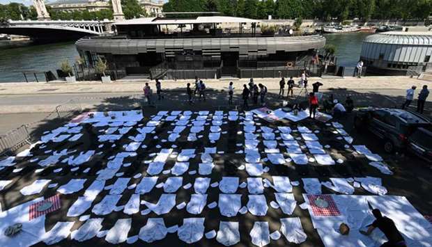 Dozens of chefsu2019 white coats, tuques, and restaurant trays are displayed on the ground of a bank of the Seine river in Paris as part of a nationwide demonstration of restaurant owners against the consequences of the measures adopted by the French government to curb the spread of the coronavirus.