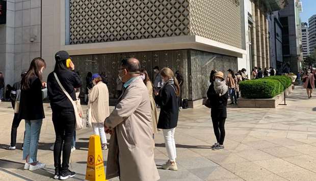 People queue to enter the Chanel boutique at a department store amid the coronavirus disease outbreak, in Seoul. South Koreans have been flocking to shops since the government this month began easing social distancing guidelines aimed at containing the virus, indicating a release of pent-up demand from people who refrained from going outdoors.