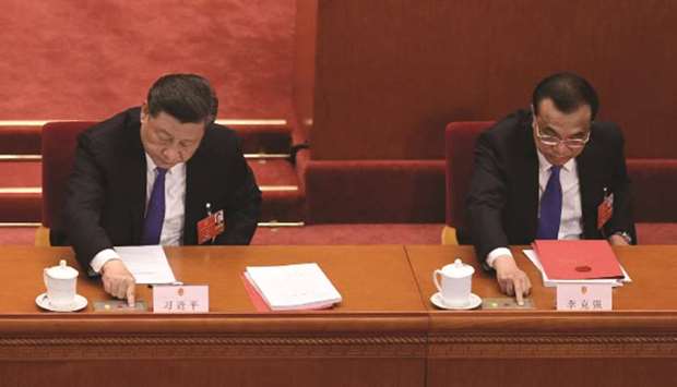 Chinau2019s President Xi Jinping and Premier Li Keqiang vote on a proposal to draft a Hong Kong security law during the closing session of the National Peopleu2019s Congress at the Great Hall of the People in Beijing yesterday.