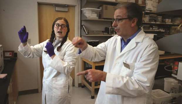 SPOTLIGHT: Purdue University biochemistry graduate student Emma Lendy talks with Andy Mesecar, one of the leading scientists identifying protein targets for potential Covid-19 drug therapies, last month on campus at Purdue in West Lafayette, Indiana.