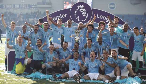 In this May 12, 2019, picture, Manchester City players pose with the trophy as they celebrate winning the Premier League in Brighton, United Kingdom. (Reuters)
