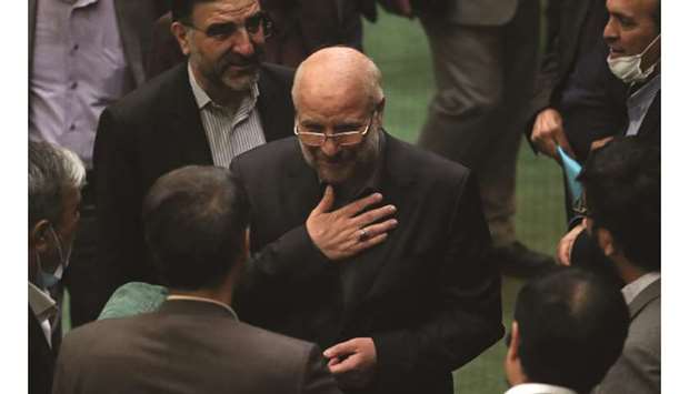 Iranian Mohamed Bagher Ghalibaf (centre) stands among members of the parliament after being elected as parliament speaker at the Iranian parliament in Tehran yesterday.