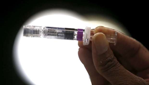 FILE PHOTO: A nurse displays a flu vaccine at a free medical and dental health clinic in Los Angeles, California, US.