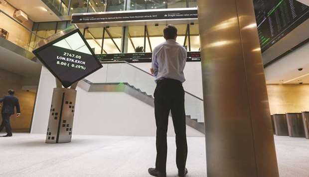 A visitor looks at a ticker of share prices inside the London Stock Exchange (file). The FTSE 100 closed down 2.5% to 6,061.43 points yesterday.