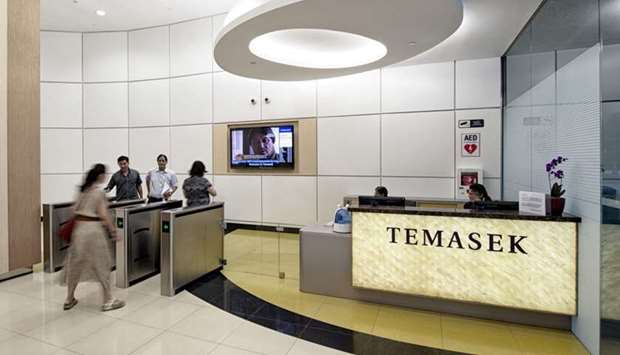 Signage for Temasek Holdings is displayed in the lobby at the companyu2019s headquarters as employees pass through electronic gates in Singapore. The company is the worldu2019s 10th biggest container carrier, with 1.5% of the market, according to data from Alphaliner. It has been selling its vessels in the last year as part of its efforts to raise funds to ease some of its financial strains.