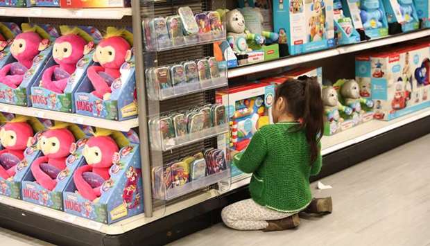A girl looks at toys on display at a store in New York. The Commerce Department said consumer spending, which accounts for more than two-thirds of US economic activity, plunged 13.6% last month, the biggest drop since the government started tracking the series in 1959.