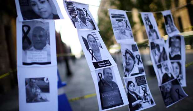 Photographs of healthcare workers who died from the coronavirus disease hang while health workers attend a demonstration in front of the National Palace to ask the Mexico's government to provide more means and better working conditions to hospitals workers, following the outbreak of the coronavirus disease, in Mexico City