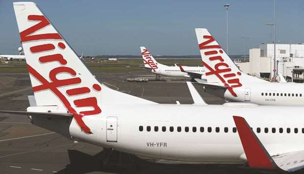 Grounded aircraft operated by Virgin Australia Holdings stand on the tarmac at Sydney Airport. The carrieru2019s problems are amplified by years of losses and a severe revenue shortfall from coronavirus-linked travel cancellations.