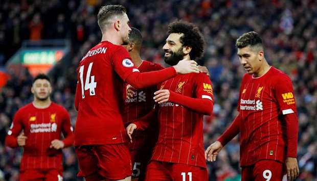 In this February 1, 2020, picture, Liverpoolu2019s Mohamed Salah (centre) celebrates their goal with Jordan Henderson (left) during the Premier League match against Southampton in Liverpool. (Reuters)
