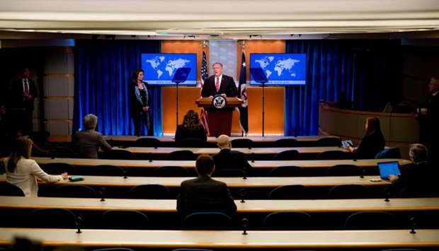 US Secretary of State Mike Pompeo, accompanied by State Department spokeswoman Morgan Ortagus(L) speaks at a news conference at the State Department on April 29