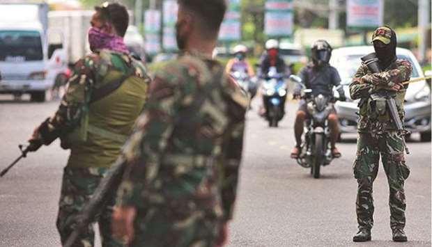 Philippine National Police (PNP) and soldiers from the Philippine Air Force (PAF) are on joint patrol to enforce strict physical distancing and community quarantine protocols at Kadiwa Market in Dasmarinas City, Cavite Province.