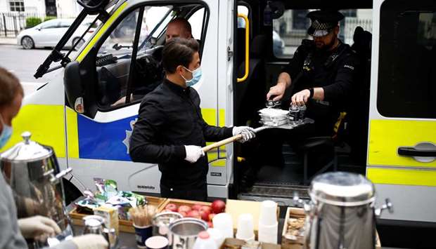 Staff at The Berkeley hotel in London give food to police officers, following the outbreak of the coronavirus disease.