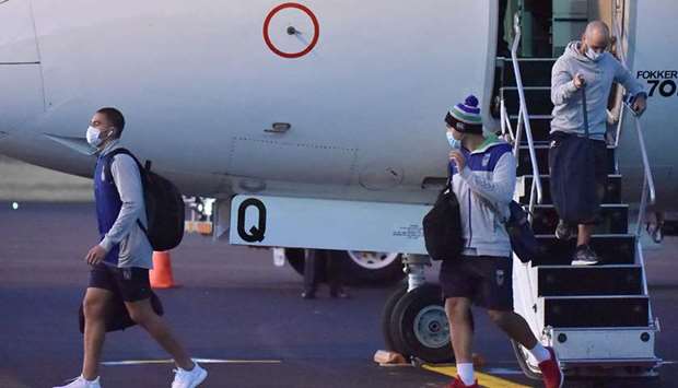 New Zealand Warriors rugby league team players alight from a plane after arriving in Tamworth yesterday. (AFP)