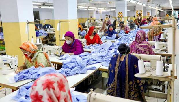 Women work in a garment factory, as factories reopened after the government has eased the restrictions amid concerns over the coronavirus disease outbreak in Dhaka, Bangladesh