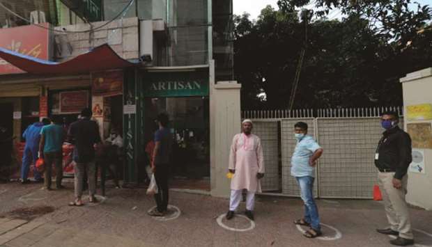 People queue to buy Iftar food during a government-imposed lockdown as a preventative measure against the spread of the coronavirus disease (Covid-19), in Dhaka yesterday.