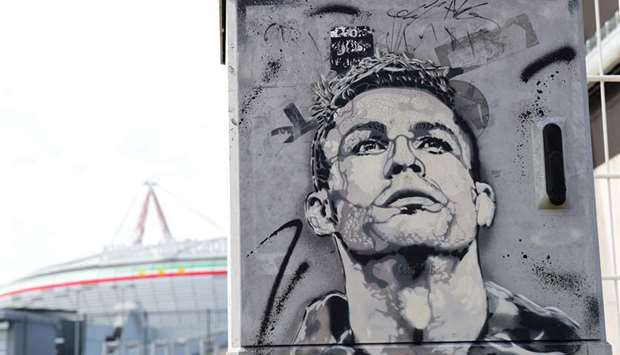 A mural of Juventusu2019 star Cristiano Ronaldo is seen outside clubu2019s Allianz Stadium in Turin, Italy, yesterday. (Reuters)