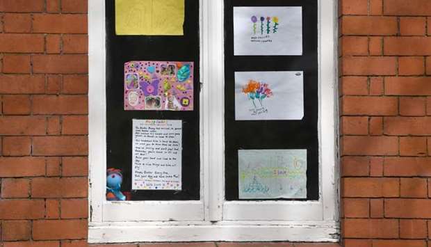 Messages of support for the residents are displayed in the windows of Peel Moat care home in Stockport, Greater Manchester, northwest England, on April 15, 2020