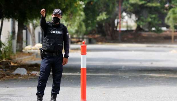 A member of the La Guaira state police gestures at a road checkpoint, after Venezuela's government announced a failed ,mercenary, incursion, in Macuto, Venezuela
