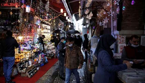 People wearing face masks shop at Eminonu district, amid the spread of the coronavirus disease, in Istanbul on May 4