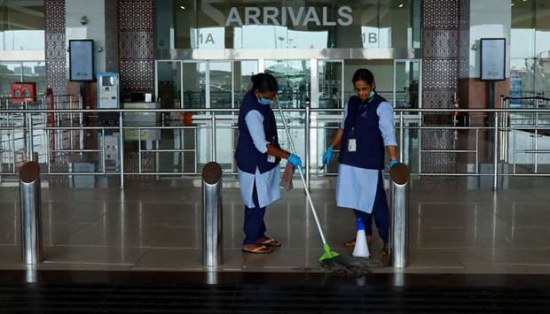 Airport staff cleans the arrivals terminal at the Cochin International Airport ahead of the arrival of an evacuation flight, yesterday.