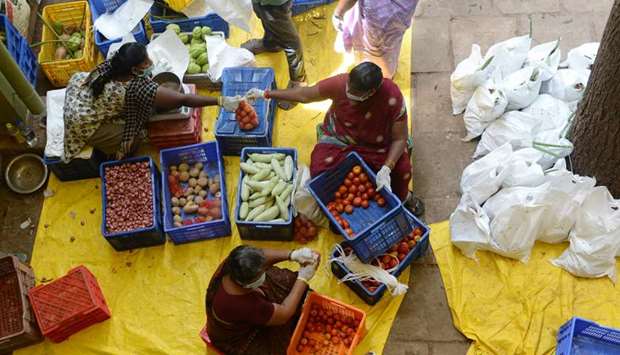 Workers wearing facemasks pack pre-ordered vegetables for distribution at the Tamil Nadu Horticulture Centre in Chennai yesterday.