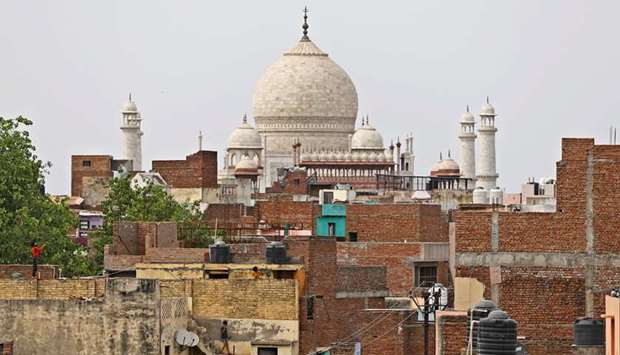 Children play on the roof of their houses as historic Taj Mahal is seen in the background during a nationwide lockdown to slow the spread of the coronavirus disease (Covid-19), in Agra, in this April 23 photograph.