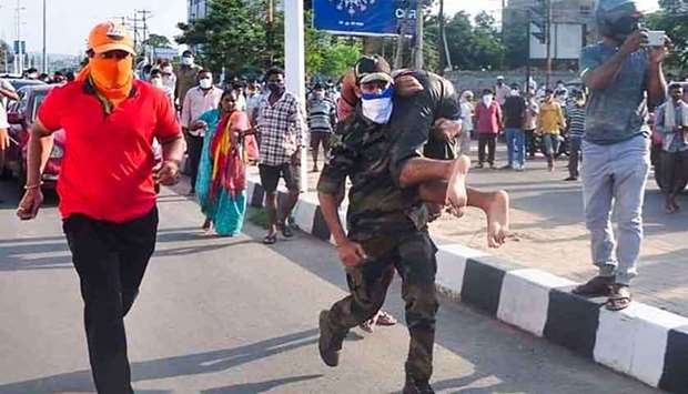 Rescuers evacuate people following a gas leak incident at an LG Polymers plant in Visakhapatnam yesterday.