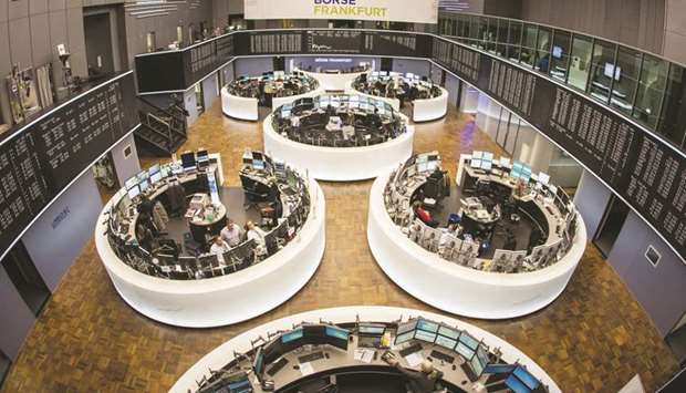 Traders work at the Frankfurt Stock Exchange. The DAX 30 closed up 1.4% to 10,904.48 points yesterday.