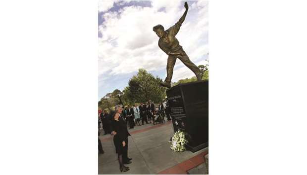 In this file photo taken on October 20, 2004, Marie (left), the widow of Australian cricketer Keith Miller, looks at the statue of her late husband at the Melbourne Cricket Ground. Miller was a fighter pilot who flew night missions over Nazi Germany in World War II. (AFP)