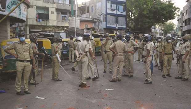 Gujarat Police personnel arrive in Shahpur area yesterday after incidents of stone pelting during a government-imposed nationwide lockdown as a preventive measure against the spread of the coronavirus.