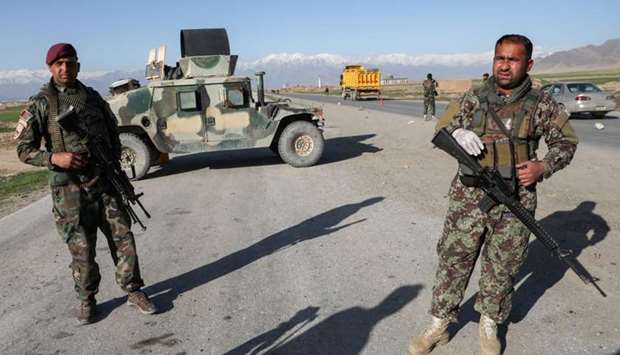 Afghan National Army (ANA) soldiers stand guard at a check point near the Bagram Airbase north of Kabul, Afghanistan on April 2.