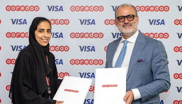 Ooredoo and Visa officials after the signing of the MoU.rnrn