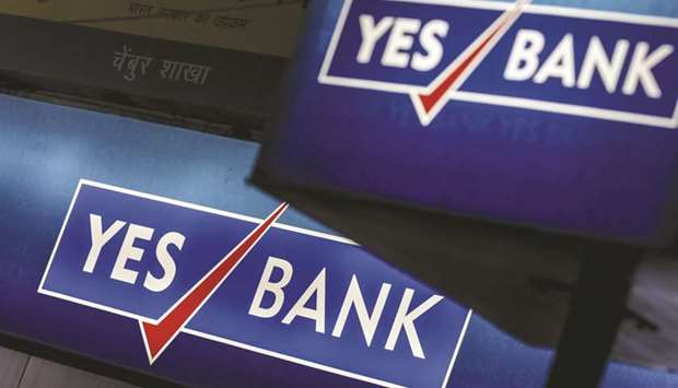 Signage for Yes Bank is displayed at a branch in Mumbai. The bank aims to raise Rs100bn to Rs120bn ($1.3bn to $1.6bn) of equity capital, preferably via a follow-on public issue by mid-July that will last for the next two years, its new chief executive officer Prashant Kumar said.