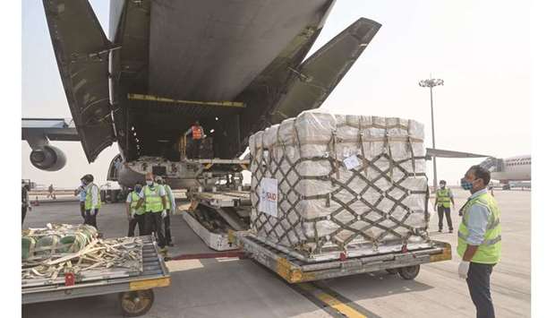 Ground staff unload coronavirus disease (Covid-19) relief supplies from the United States at the Indira Gandhi International Airport cargo terminal in New Delhi, yesterday.