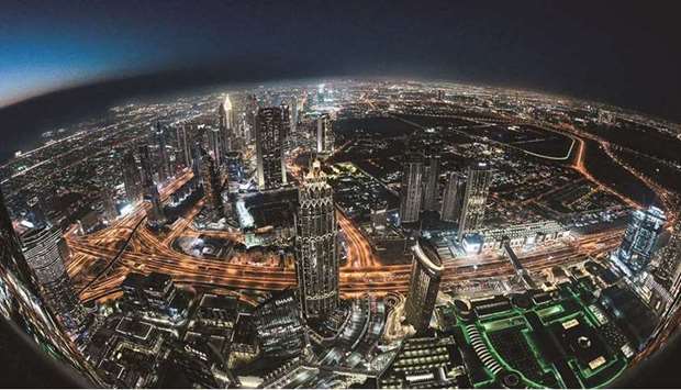 Picture taken with a fish-eye lens on May 9 shows a view of the Dubai city skyline as seen from the Burj Khalifa, currently the worldu2019s tallest building. Business activity in Dubai rose to the highest level since late 2019 after a rebound in tourism and a fast distribution of coronavirus vaccines.