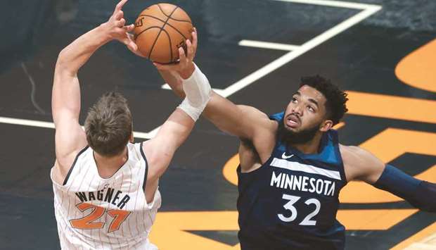 Minnesota Timberwolves center Karl-Anthony Towns (right) defends Orlando Magic center Moritz Wagneru2019s shot during the first half at Amway Center in Orlando, Florida, USA. (USA TODAY Sports)