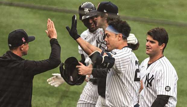 New York Yankeesu2019 Giancarlo Stanton (centre) celebrates with teammates and coaches after hitting a walk-off single against the Washington  Nationals at Yankee Stadium in New York. (USA TODAY Sports)