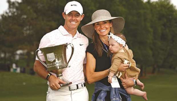 Rory McIlroy of Northern Ireland celebrates with the trophy alongside his wife Erica and daughter Poppy after winning the 2021 Wells Fargo Championship at Quail Hollow Club in Charlotte, North Carolina. (Getty Images/AFP)