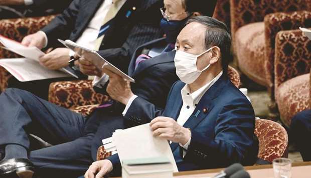 Japanu2019s Prime Minister Yoshihide Suga (R) attends a lower house budget committee session in Tokyo yesterday.
